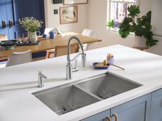 The sink is the heart of the kitchen, and Moen is making it more efficient to move about the space with the new workstation kitchen sinks. With a workstation sink, you can transform messy routines such as rinsing, chopping, and washing into a contained, all-in-one experience right over the sink and free up valuable counter space. The workstation bundle includes a contemporary stainless-steel undermount sink and high-quality accessories such as a bottom sink grid, colander, hardwood cutting board, flexible drying rack, and drain strainer/cover. The sink also includes a built-in ledge to secure accessories or slide them over to tailor your workstation to meet your needs. Moen Luxe Chef Undermount 33-in x 19-in Stainless Steel Double Equal Bowl Workstation Kitchen Sink | GS182040BUX Sink Trends, Best Kitchen Sinks, Kitchen Faucet With Sprayer, Kitchen Sink Design, Sink Grid, Fireclay Sink, Single Bowl Sink, Double Bowl Sink, Over The Sink