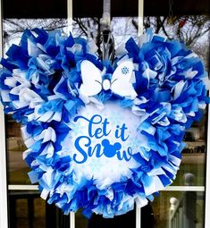 a blue and white wreath that says let it snow