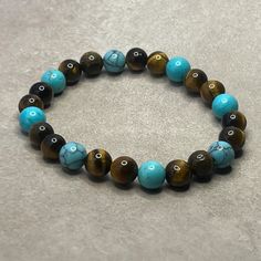 Discover the perfect gift that radiates positive energy and style - our Blue Turquoise and Tiger Eye Bracelet. Not just a piece of jewelry, this bracelet is a source of comfort, designed to help with anxiety and stress relief. Crafted with care, this 7 Chakra Bracelet combines the soothing properties of Turquoise and the grounding energy of Tiger Eye. The striking 8mm Turquoise beads evoke the tranquil waters of the ocean, making it an ideal choice for beach lovers. Paired with Tiger Eye, this bracelet symbolizes inner strength and balance, reminding you of the steady tides and resilience of nature. MEASURE YOUR WRIST or Anklet: - Measure around at the wrist bone in tape or even a strip of paper. - Choose a place where you would normally wear a bracelet. Make it as loose or snug. - To use 7 Chakra Bracelet, Grounding Energy, Boho Beauty, Tiger Eye Bracelet, 7 Chakra, Bracelet Blue, Chakra Bracelet, Eye Bracelet, Beach Lovers