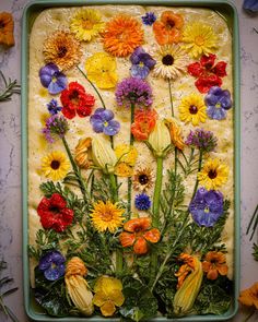 an arrangement of colorful flowers on a tray