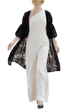 Swirling soutache ribbons pattern a ready-to-layer ruana fashioned in a lightweight, open-front silhouette framed by billowy balloon sleeves. Open front Three-quarter sleeves 100% polyester Hand wash, line dry Imported Elegant Spring Wrap Shrug, Black Spring Evening Shrug, Black Evening Shrug For Spring, Elegant Black Shrug For Spring, Elegant Open Front Shrug For Spring, Black Shrug For Evening In Spring, Elegant Spring Shawl Outerwear, Elegant Long Sleeve Beach Outerwear, Elegant Beach Outerwear With Open Front