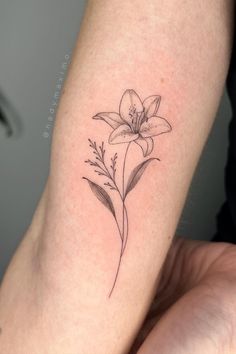 a woman's arm with a flower tattoo on the left side of her body