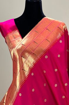 This exquisite regal paithani saree is handwoven in rani pink shot with vermillion red. Gold silver zari dollar buttis adorn the body while the gold zari border is decorated with handwoven triple line of parrots that we call triple muniya border. The elaborate pallu is woven with colorful Peacocks along with winding vines. The saree comes with plain blouse with matching borders. Approximate Length 6.5 mtrs (inclusive of blouse length)Height - 48- 52" Saree comes with fall, picot and tassels done. Blouse piece is cut. Approximate weight - 1.8 lbs Kindly Note : The colors you see on your device may vary due to the color reproduction, brightness and resolution of individual devices. If you'd like more clarity before your purchase, please contact our support team. *** Readymade blouse is not p Pink Traditional Wear With Border For Puja, Pink Raw Silk Saree With Border, Pink Raw Silk Dupatta With Border, Red Paithani Silk Saree With Border, Pink Paithani Silk Traditional Wear With Patterns, Pink Paithani Silk Saree With Traditional Patterns, Pink Paithani Silk Traditional Wear With Traditional Patterns, Ceremonial Pink Saree With Cutdana, Pink Traditional Wear With Paithani Silk And Traditional Patterns