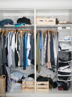 an organized closet with clothes and boxes