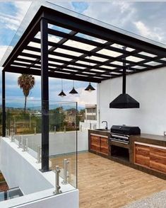 an outdoor kitchen with grill, sink and counter top