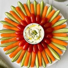 a white plate topped with carrots, celery and cucumber sticks