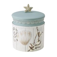 a ceramic jar with shells and starfish on it