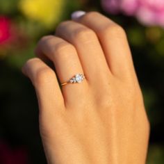 a woman's hand with a diamond ring on it