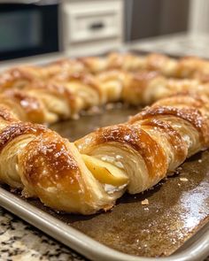 a baked pastry on a baking sheet with powdered sugar