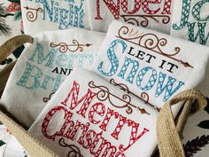 four hand embroidered christmas napkins in a basket