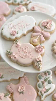 decorated cookies are displayed on white plates