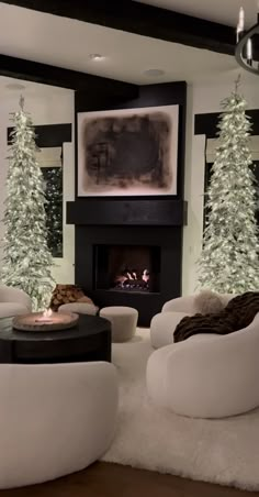 the living room is decorated for christmas with white furniture and trees in front of it