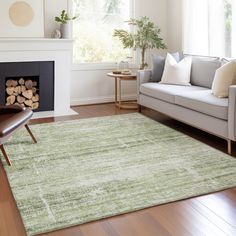 a living room filled with furniture and a fire place in front of a window on top of a hard wood floor