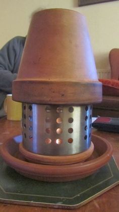 a large metal pot sitting on top of a wooden table