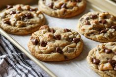 chocolate chip cookies sitting on top of a baking sheet