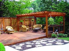 a wooden deck surrounded by furniture and trees