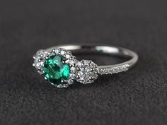 Welcome to my shop, you can find many beautiful gemstone jewelry here, and you also can ask for customized service. Main Stone: lab emerald ,round cut, measures 6X6mm, weight about 0.84 carats.Accent Stones: czMetal: 925 sterling silver plated with rhodium. I also can provide metal options such as 14k solid yellow/white/rose goldSetting: prong settingmore rings: https://www.etsy.com/shop/XCjewelryStudio?ref=hdr_shop_menuIt's a perfect gift for the person who was born in July(Birthstone), It's qu Emerald Diamond Halo Promise Ring, Emerald Diamond Ring With Halo For Promise, Emerald Halo Diamond Ring For Promise, Emerald Cluster Ring With Halo Design, Dazzling Emerald Ring With Halo Setting For Promise, Silver Emerald Ring With Halo Detail, Emerald Ring With Halo For May Birthstone, Emerald Cluster Ring With Halo Design For Promise, Silver Emerald Ring With Halo