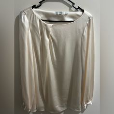 Chic Ivory Colored Satin Blouse With Long Sleeve And Silver Buttons. Brand New. Elegant Cream Office Tops, Elegant Cream Long Sleeve Tops, Elegant Long Sleeve Cream Tops, Chic Cream Formal Top, Elegant Long Sleeve Cream Blouse, Spring Cream Blouse For Formal Occasions, Cream Long Sleeve Blouse For Evening, Spring Formal Cream Blouse, Cream Blouse For Spring Formal Occasions