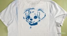 a white t - shirt with a dog's face painted on it and blue ink