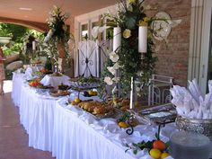 a long table with food on it in front of a building