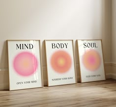 three framed posters with the words mind, body and soul on them in front of a wooden floor