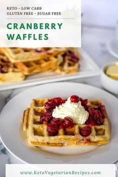 two waffles with whipped cream and strawberries on top, sitting next to each other