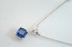 "HERE IS BEAUTIFUL CUSHION CUT CEYLON BLUE SAPPHIRE & DIAMOND SOLITAIRE PENDANT NECKLACE 14 KARAT WHITE GOLD COMES WITH 16\" OR 18\" INCH CHAIN CENTER AA CUSHION CUT CEYLON BLUE SAPPHIRE VERY SWEET BLUE COLOR & CLEAN SAPPHIRE !! CENTER SHAPE- CUSHION CUT CUT- VERY GOOD CLARITY- AA COLOR- BLUE CARAT- 0.80ct MEASUREMENT- 5.00 X 5,00mm 1 WHITE DIAMOND 0.04ct SI1 G COLOR TOTAL 0.84 CARAT CLEAN AND BRIGHT WHITE COLOR DIAMOND!! RETAIL PRICE IS OVER $2,500.00 COMES WITH $1,900.00 CERTIFIED APPR Formal Blue Diamond Cut Necklace, Formal Blue Sapphire Necklace, Formal Blue Diamond Cut Necklaces, Luxury Blue Necklace With Prong Setting, Classic Blue Necklace With Diamond Accents, Classic Blue Pendant Necklace, Classic Blue Necklace For Anniversary, Classic Blue Necklaces For Anniversary, Classic Blue Sapphire Necklace