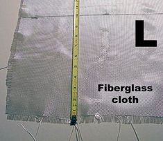 there is a piece of cloth with a measuring tape on it that says fiberglass cloth