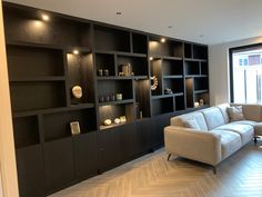 a living room filled with furniture and shelves