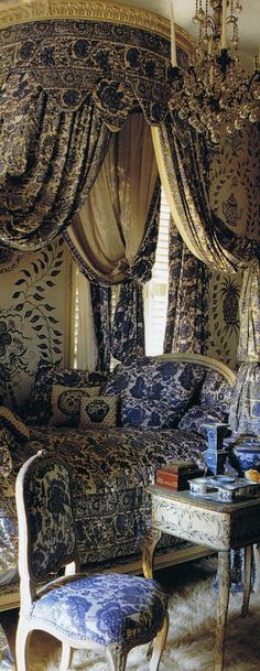 an ornate bedroom with blue and white decor