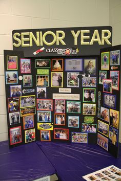 a purple table topped with pictures next to a sign that reads senior year class 2012