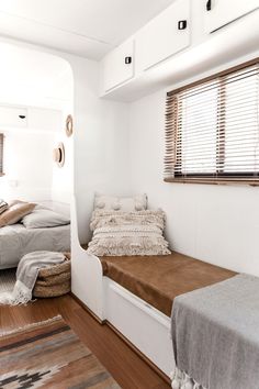 an image of a bedroom with white walls and wood flooring on the phone screen