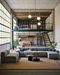 a living room filled with lots of furniture next to a fire place and staircase leading up to the second floor