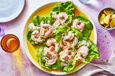 a yellow plate topped with lettuce covered in shrimp