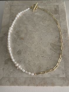 Half freshwater pearl, half 24k gold filled paperclip chain necklace with toggle clasp. Necklace Length 16.5 inches. Clasp size is 14mm. Each pearl is unique in shape therefore, each necklace will appear slightly different. Paperclip Chain And Pearl Necklace, Minimalist Gold Pearl Necklace With Paperclip Chain, Gold Pearl Necklace With Paperclip Chain, Gold Necklace With Baroque Pearl And Paperclip Chain, Chain Necklace Diy, Toggle Clasp Necklace, Paperclip Chain Necklace, Toggle Necklace, Clasp Necklace