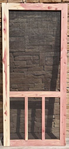 the shadow of a person standing in front of a brick wall behind a wooden window