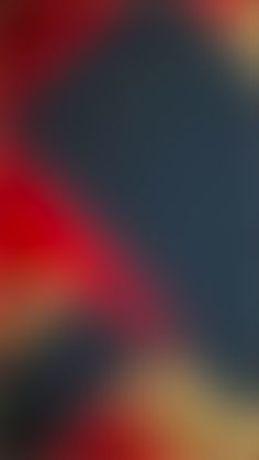 a blurry image of an orange and black background with red, yellow, and blue colors