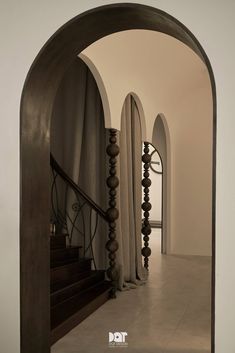 an arched doorway leading to a set of stairs