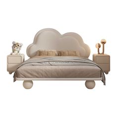 a bed with a cloud shaped headboard and night stands