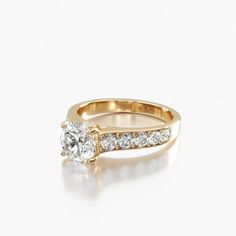 a rose gold engagement ring set with a round diamond and channeled diamonds on the band