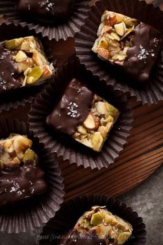 several pieces of chocolate with nuts on top