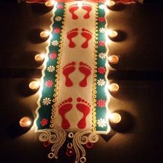 a lighted sign with footprints on it in the dark