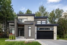 a modern house with two garages in the front yard