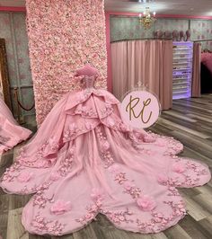 a pink wedding gown with flowers on it