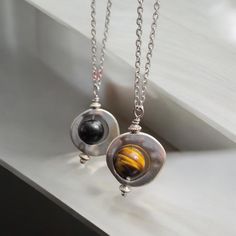 Discover serenity and style with our Small Spinning Fidget Pendant Necklace. This charming piece is not only a beautiful accessory but also a soothing tool to help calm the mind and ease stress. The pendant features a delicate spinning mechanism that can be gently twirled between your fingers, providing a tactile and meditative experience. Metal - silver filled  Stones - tiger eye , black shungite  Pendant size - 1 inch  Necklace length - custom  Style - fidget necklace, spinning pendant, everyd Spinning Mechanism, Fidget Necklace, Eye Black, Necklace Length, Necklace For Women, Tiger Eye, Jewelry Gift, Natural Gemstones, Womens Necklaces