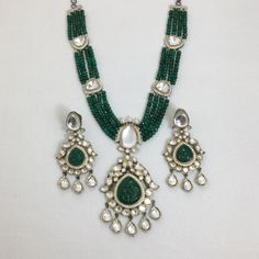 Make a statement with this exquisite green Kundan long necklace. Featuring a Victorian-inspired Polki pendant with a dazzling emerald, this Sabyasachi-inspired piece is crafted in premium dual-tone Jadau. Perfect for any special occasion, it combines timeless elegance with luxurious craftsmanship to enhance your unique style. *𝐏𝐑𝐎𝐃𝐔𝐂𝐓 𝐃𝐄𝐓𝐀𝐈𝐋* * Material: Brass * Plating: Gold Plated * Stone: Kundan, Polki & Emerald. *𝐃𝐈𝐌𝐄𝐍𝐒𝐈𝐎𝐍𝐒* *Necklace* * Weight: 71 gm * One Side Length Elegant Green Kundan Necklace With Meenakari, Bollywood Emerald Necklace For Festive Occasions, Bollywood Style Festive Emerald Necklaces, Bollywood Style Festive Emerald Necklace, Green Emerald Temple Jewelry Necklace For Celebration, Green Emerald Necklace For Celebrations, Temple Style, Elegant Green Chandbali Kundan Necklace, Green Emerald Necklace For Diwali, Temple Jewelry Style, Elegant Green Meenakari Bridal Necklace