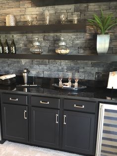 a kitchen counter with wine glasses on it