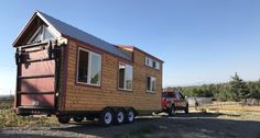 a truck is parked next to a tiny house