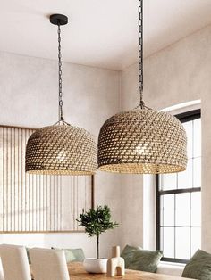 two chandeliers hanging over a dining room table