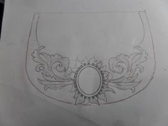 a drawing of an oval frame with flowers and leaves around it, on top of a piece of paper